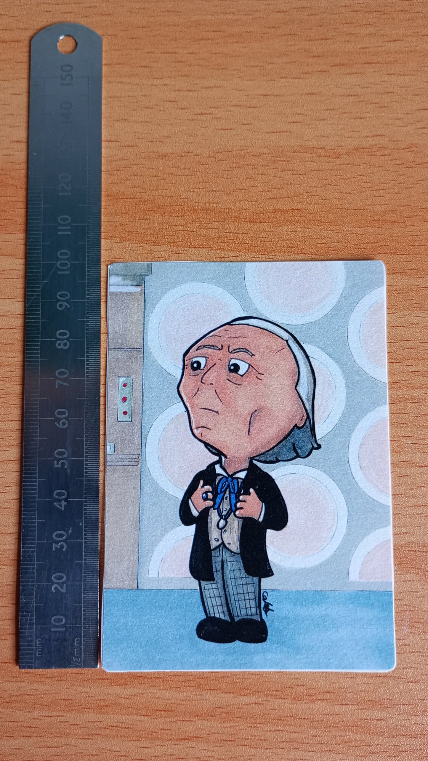 Large rectangular sticker with a picture of a Chibi Doctor Who drawing next to a ruler for scale. The ruler shows that the sticker is 10 cm tall (or 100 millimetres)